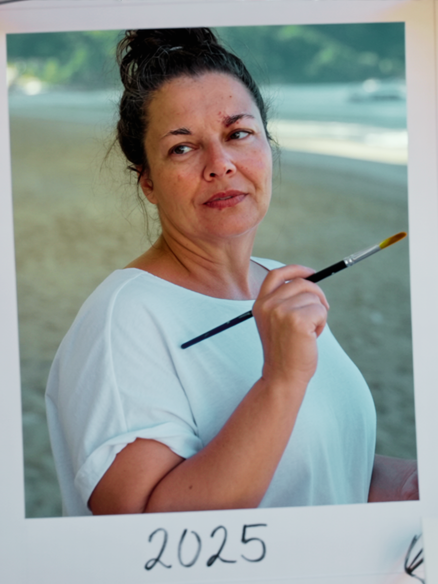 Amanda Palmer, artist and painter, holding a paintbrush in her studio